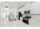 Bright kitchen features white cabinets, stainless steel appliances, subway tile backsplash and large island at 6434 Astor Elgin St, Raleigh, NC 27616