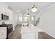 Open-concept kitchen and living area with modern stainless steel appliances at 6434 Astor Elgin St, Raleigh, NC 27616