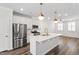 Well-lit kitchen with stainless steel appliances, center island, and modern pendant lights at 6434 Astor Elgin St, Raleigh, NC 27616