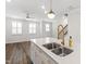 Stylish kitchen island with stainless sink and a modern golden faucet at 6434 Astor Elgin St, Raleigh, NC 27616