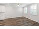 Open-concept living room with hardwood floors and plenty of natural light at 6434 Astor Elgin St, Raleigh, NC 27616
