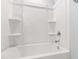 A bright white bathtub shower combo with built-in shelving at 6434 Astor Elgin St, Raleigh, NC 27616