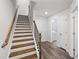 Bright staircase with wood treads and white risers, leading to upper levels with adjacent doorways at 6434 Astor Elgin St, Raleigh, NC 27616