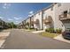 Exterior shot of community featuring rows of townhomes, attached garages, and street parking at 6434 Astor Elgin St, Raleigh, NC 27616