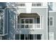 Exterior view showcases a balcony with white railings and a lattice-covered ceiling on a multi-story building at 700 Bishops Park Dr # 205, Raleigh, NC 27605
