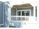 Balcony with white railings and lattice detail, offering a charming outdoor space with a sliding glass door entrance at 700 Bishops Park Dr # 205, Raleigh, NC 27605
