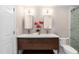 Bright bathroom featuring double sinks, modern fixtures, and stylish cabinetry and a white toilet at 700 Bishops Park Dr # 205, Raleigh, NC 27605