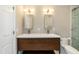 Renovated bathroom with dual sink vanity, modern fixtures, and a glass enclosed shower at 700 Bishops Park Dr # 205, Raleigh, NC 27605