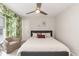 Comfortable bedroom featuring a ceiling fan, neutral decor, and a gray tufted headboard for a modern touch at 700 Bishops Park Dr # 205, Raleigh, NC 27605