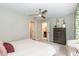 Bright bedroom with a ceiling fan, neutral colors, and convenient access to the ensuite bathroom at 700 Bishops Park Dr # 205, Raleigh, NC 27605