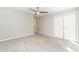 Spacious bedroom with plush carpet, ceiling fan, and a double door closet at 700 Bishops Park Dr # 205, Raleigh, NC 27605