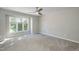 Bright bedroom with large windows offering natural light and a ceiling fan at 700 Bishops Park Dr # 205, Raleigh, NC 27605