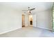 Neutral bedroom with ceiling fan, carpet, and access to two bathrooms at 700 Bishops Park Dr # 205, Raleigh, NC 27605
