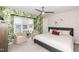 Comfortable bedroom with leafy wallpaper, a ceiling fan, and neutral-colored furniture and decorations at 700 Bishops Park Dr # 205, Raleigh, NC 27605