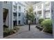 Courtyard view with beautiful gray condos and a brick pathway at 700 Bishops Park Dr # 205, Raleigh, NC 27605