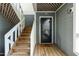 Charming entrance featuring wooden steps, a glass-paneled door with the unit number, and a welcoming doormat at 700 Bishops Park Dr # 205, Raleigh, NC 27605