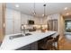 Modern kitchen with stainless steel appliances, quartz countertops, and stylish pendant lighting at 700 Bishops Park Dr # 205, Raleigh, NC 27605