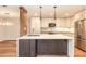 Modern kitchen boasts stainless steel appliances, an island with seating, and ample counter space for cooking at 700 Bishops Park Dr # 205, Raleigh, NC 27605