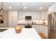 Bright, updated kitchen with stainless steel appliances, ample cabinet space, and a view of the living area at 700 Bishops Park Dr # 205, Raleigh, NC 27605