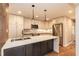 Bright kitchen features white cabinets, stainless steel appliances, and a large island with a sink and seating at 700 Bishops Park Dr # 205, Raleigh, NC 27605