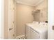 Bright laundry room with tiled floors and modern washer and dryer units at 700 Bishops Park Dr # 205, Raleigh, NC 27605