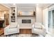 Cozy living space with a modern fireplace, built-in shelving, and easy access to the updated kitchen at 700 Bishops Park Dr # 205, Raleigh, NC 27605