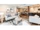 Inviting living room with a stylish sofa, modern artwork, and seamless flow into the dining and kitchen areas at 700 Bishops Park Dr # 205, Raleigh, NC 27605