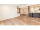 Open living space featuring hardwood floors and seamless access to the modern kitchen at 700 Bishops Park Dr # 205, Raleigh, NC 27605