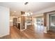 Open-concept living space with hardwood floors, modern lighting, fireplace, and kitchen view at 700 Bishops Park Dr # 205, Raleigh, NC 27605