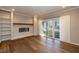 Inviting living room offers hardwood floors, built-in shelves, a fireplace, and sliding glass doors to the outside at 700 Bishops Park Dr # 205, Raleigh, NC 27605