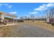 Backyard view featuring a covered patio area, a shed, and a gravel ground cover at 71 Oak Trace Dr, Four Oaks, NC 27524