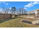 Fenced-in backyard with a shed, patio area, and mature trees offering privacy at 71 Oak Trace Dr, Four Oaks, NC 27524