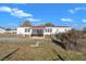 Exterior home view of a metal roof, covered patio and fenced yard surrounded by mature trees at 71 Oak Trace Dr, Four Oaks, NC 27524