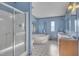 Bathroom with shower, soaking tub, double sinks and vanities, mirrors, and light blue walls at 71 Oak Trace Dr, Four Oaks, NC 27524