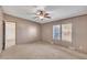 Spacious bedroom featuring neutral tones, a ceiling fan, and natural light from the double windows at 71 Oak Trace Dr, Four Oaks, NC 27524