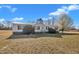 Attractive single-level home with a metal roof, neatly trimmed hedges, and a well-maintained lawn at 71 Oak Trace Dr, Four Oaks, NC 27524