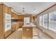 Bright kitchen featuring wood cabinetry, a central island with sink, and ample natural light at 71 Oak Trace Dr, Four Oaks, NC 27524