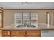 Kitchen counter with sink area offers ample natural light with three windows looking out onto green landscape at 71 Oak Trace Dr, Four Oaks, NC 27524