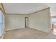 This empty living room features neutral carpet and an open doorway at 71 Oak Trace Dr, Four Oaks, NC 27524