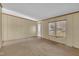 This empty living room features neutral carpet and a front door entrance at 71 Oak Trace Dr, Four Oaks, NC 27524