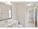 Bright bathroom featuring a white vanity with sink and a large mirror with decorative frame at 7216 Bluffside Ct, Raleigh, NC 27615