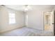 Bedroom featuring neutral carpet, ceiling fan, and a window offering a peaceful view at 7216 Bluffside Ct, Raleigh, NC 27615