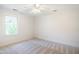 Inviting bedroom with soft carpeting, a ceiling fan, and a window offering a tranquil view at 7216 Bluffside Ct, Raleigh, NC 27615