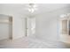 Bedroom with neutral carpet, a ceiling fan, a closet, and view to staircase at 7216 Bluffside Ct, Raleigh, NC 27615