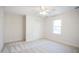 Bright bedroom with neutral carpet, ceiling fan, and window providing ample natural light at 7216 Bluffside Ct, Raleigh, NC 27615