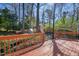Spacious deck offers serene views of the wooded backyard and storage shed at 7216 Bluffside Ct, Raleigh, NC 27615