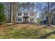 Traditional two-story home with white siding, dark shutters, and a well-maintained front lawn at 7216 Bluffside Ct, Raleigh, NC 27615