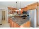 Kitchen featuring stainless steel appliances, wood cabinets, and a kitchen island at 7216 Bluffside Ct, Raleigh, NC 27615