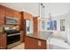 Updated kitchen with stainless steel appliances, wood cabinetry, and an island at 7216 Bluffside Ct, Raleigh, NC 27615