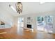 Bright living room with hardwood floors, stone fireplace, skylights, and deck access at 7216 Bluffside Ct, Raleigh, NC 27615